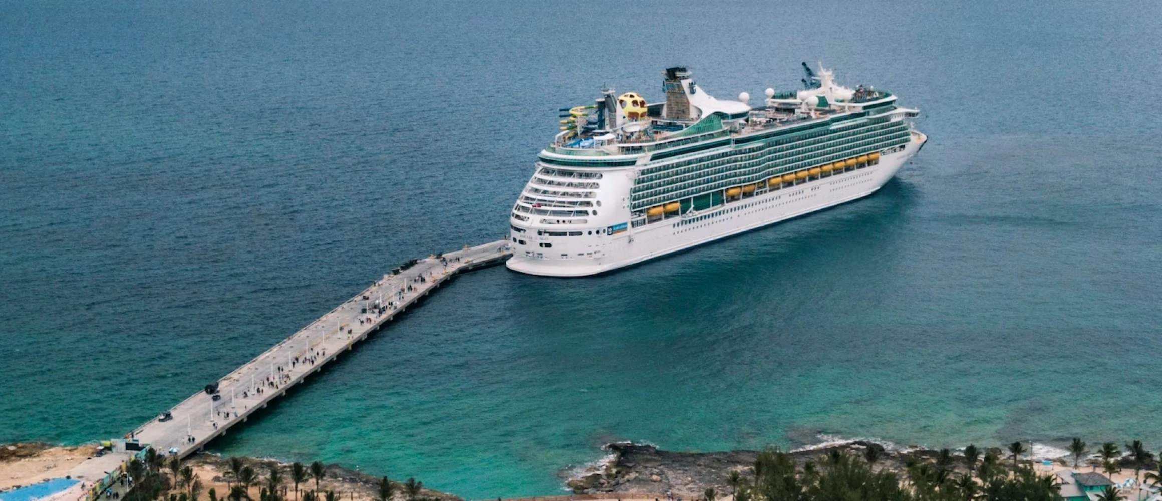 Cruise ship docked at a beautiful location