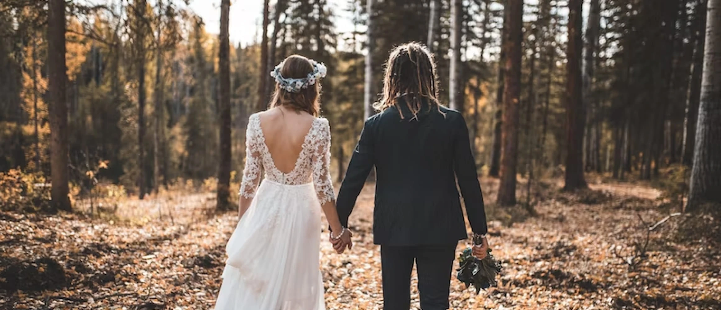 A couple walking into the woods