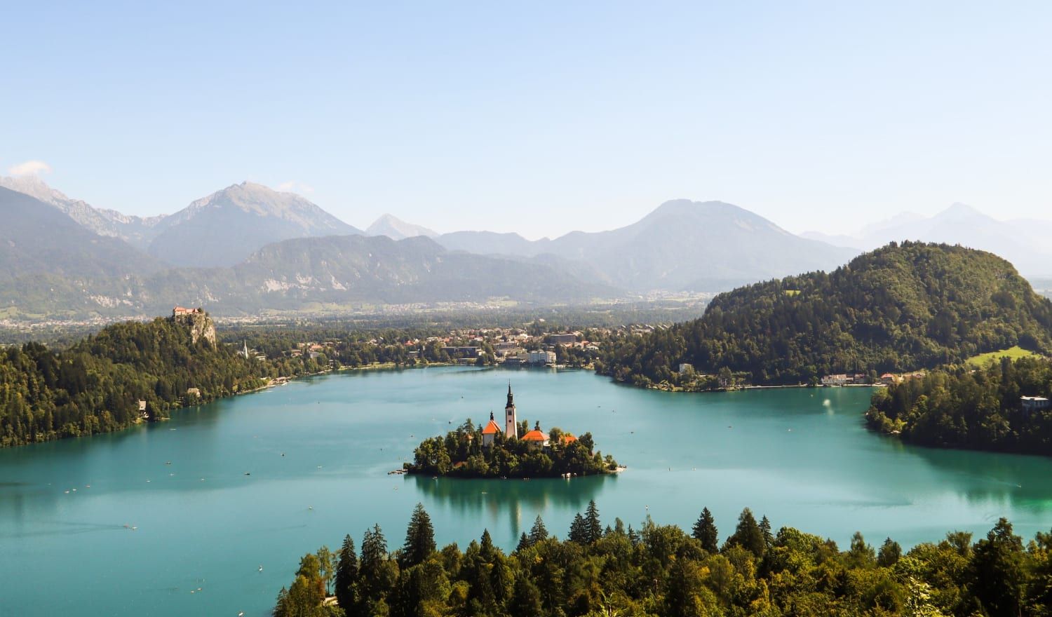 Fairy-tale Lake Bled surrounded by crystal blue waters.