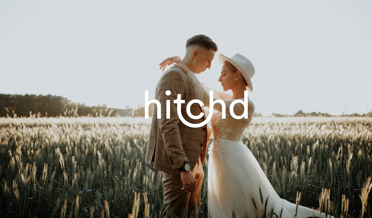 An editorial worthy wedding photograph of a beautiful couple in a field