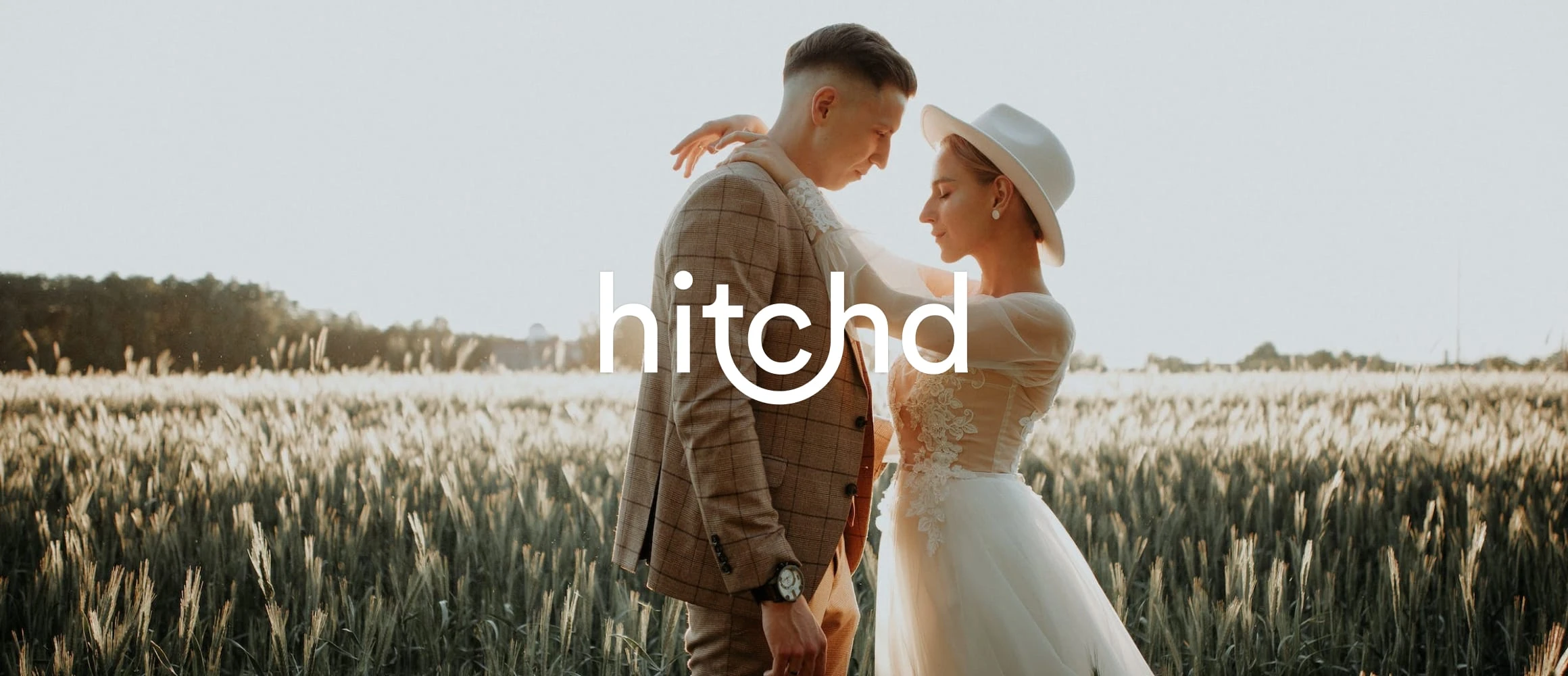 An editorial worthy wedding photograph of a beautiful couple in a field