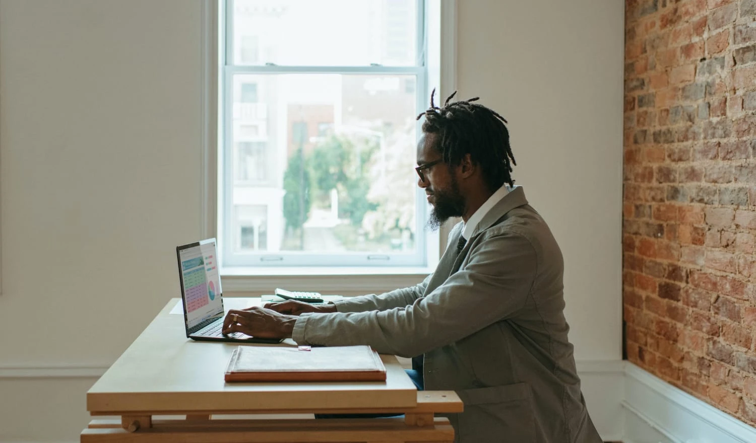 A man making typing out a budget on a computer