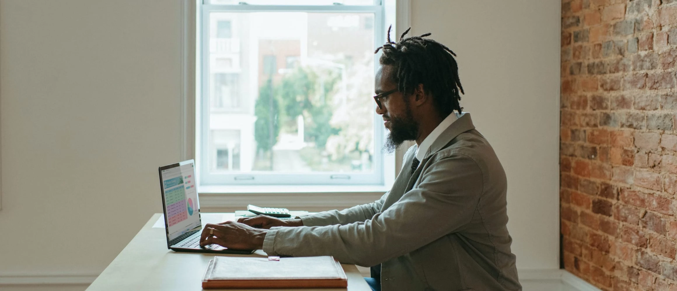 A man making typing out a budget on a computer