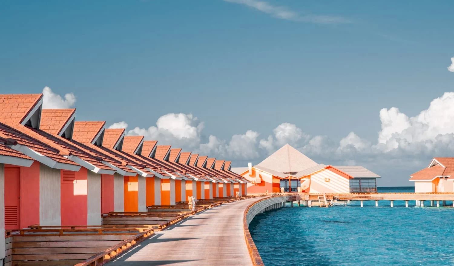 The perfect blue waters shining under bungalows in the Maldives.