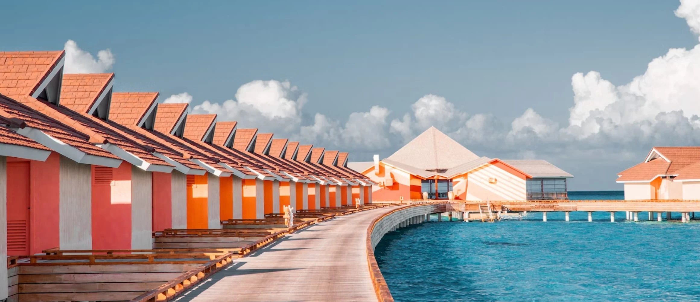 The perfect blue waters shining under bungalows in the Maldives.