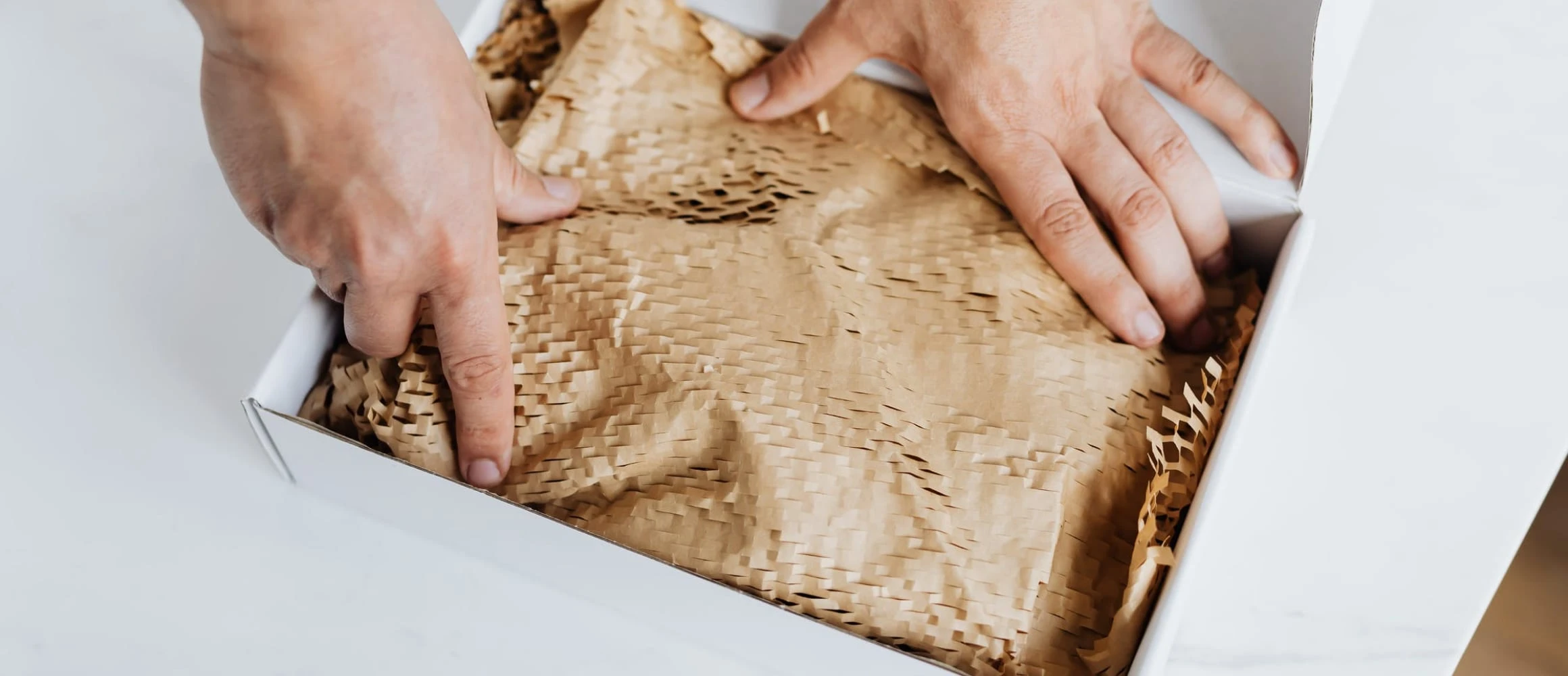 Hands packaging a gift