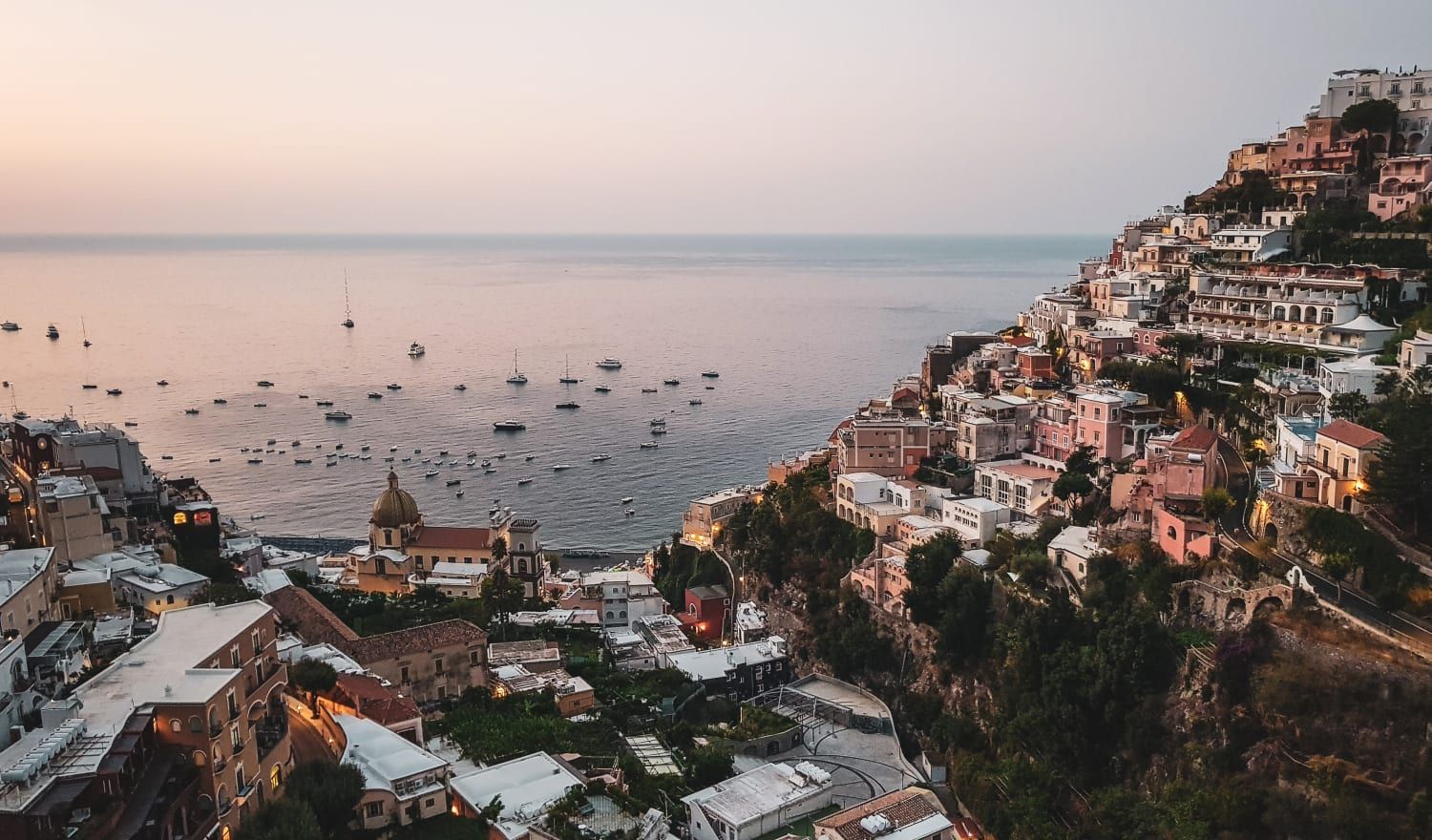 Amalfi coast at sunset. Pinks, blues, cliff side houses and plenty of boats