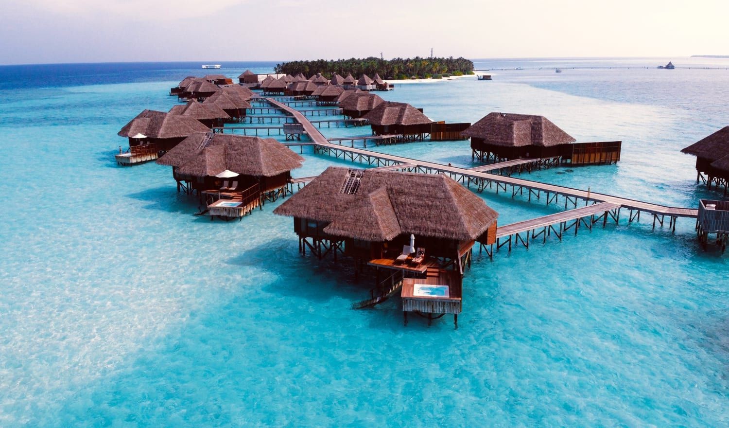 Over water bungalows standing tall on crystal blue waters