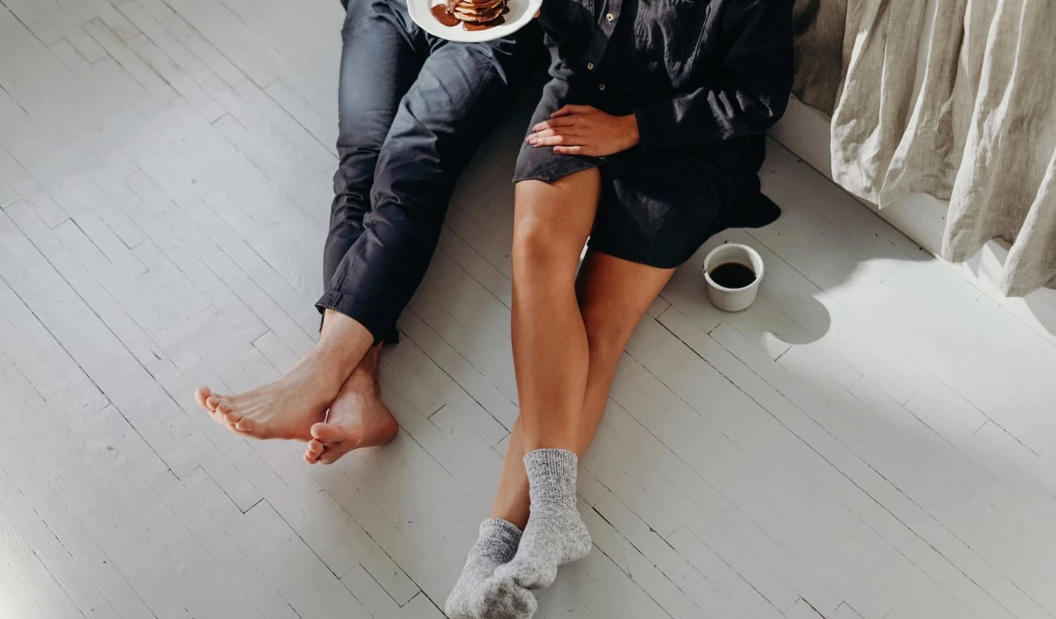 A couple sharing a burger in their home