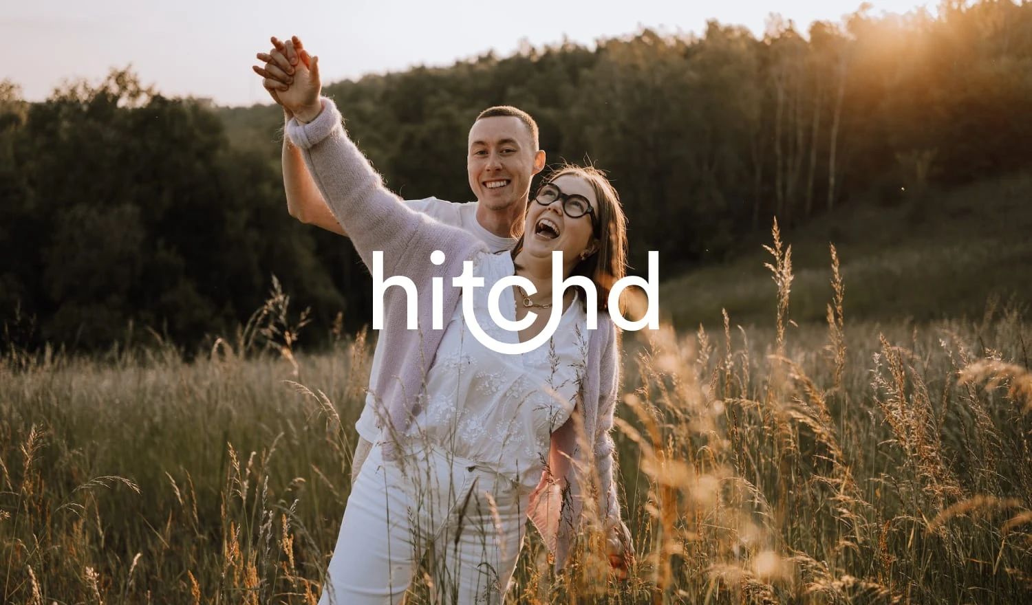 A couple laughing in a field of flowers