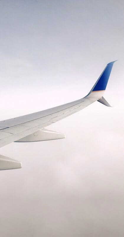 An Airplane flying through grey clouds