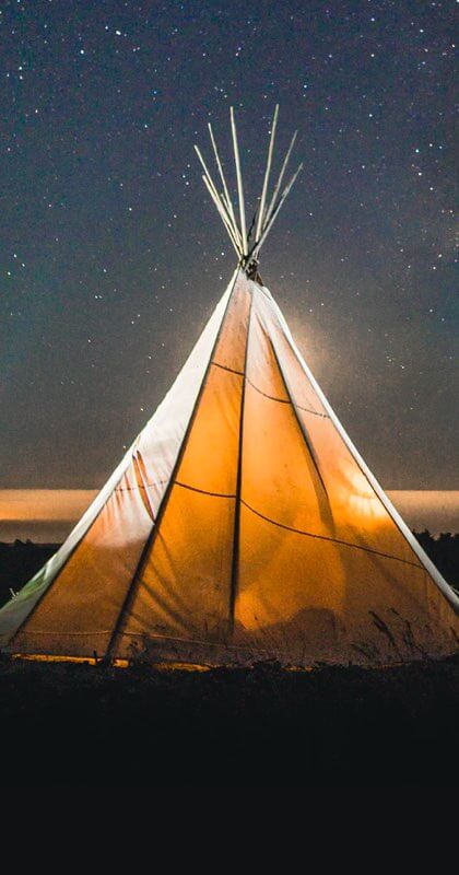 A two person luxury glamping tent set up under the stars