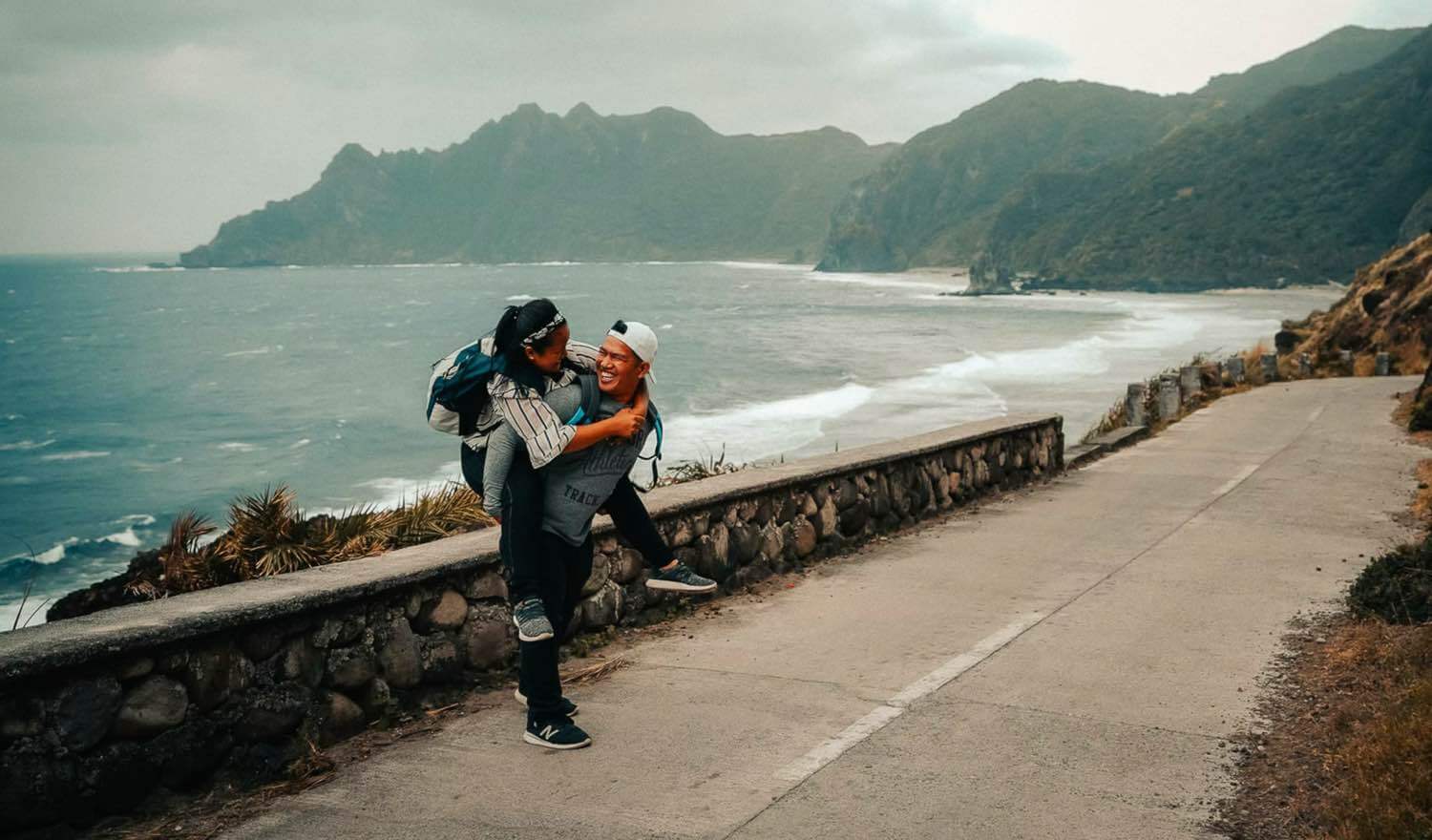 A man giving a woman a piggy back-ride