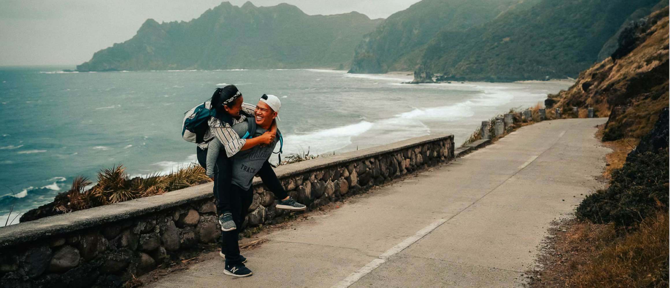 A man giving a woman a piggy back-ride