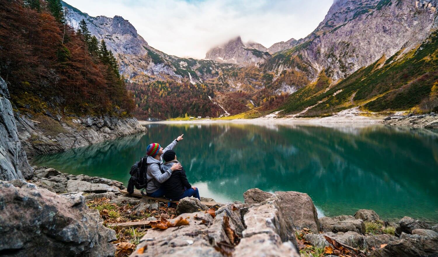 A couple looking out over a beautiful lake
