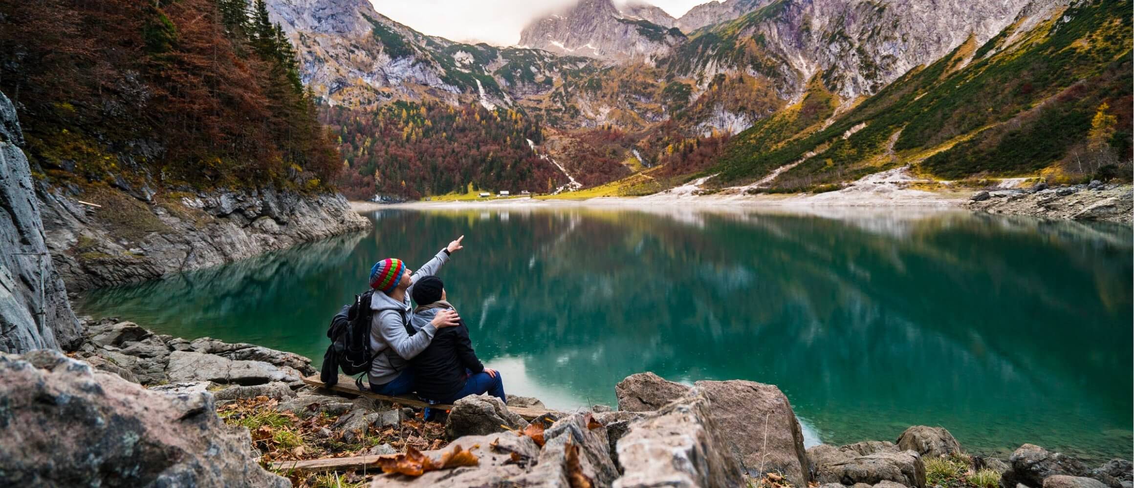 A couple looking out over a beautiful lake