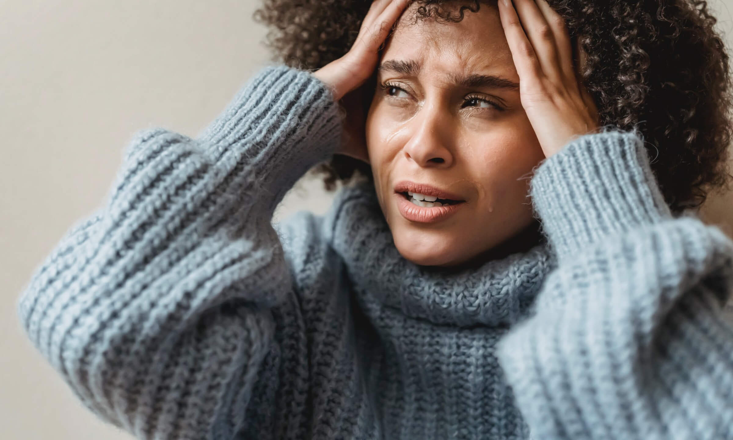 A woman grabbing fists full of her hair