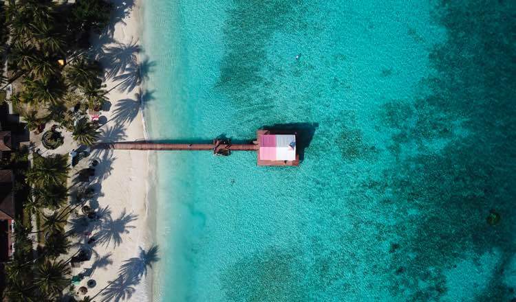 Panning aerial shot of a picturesque jetty over blue waters