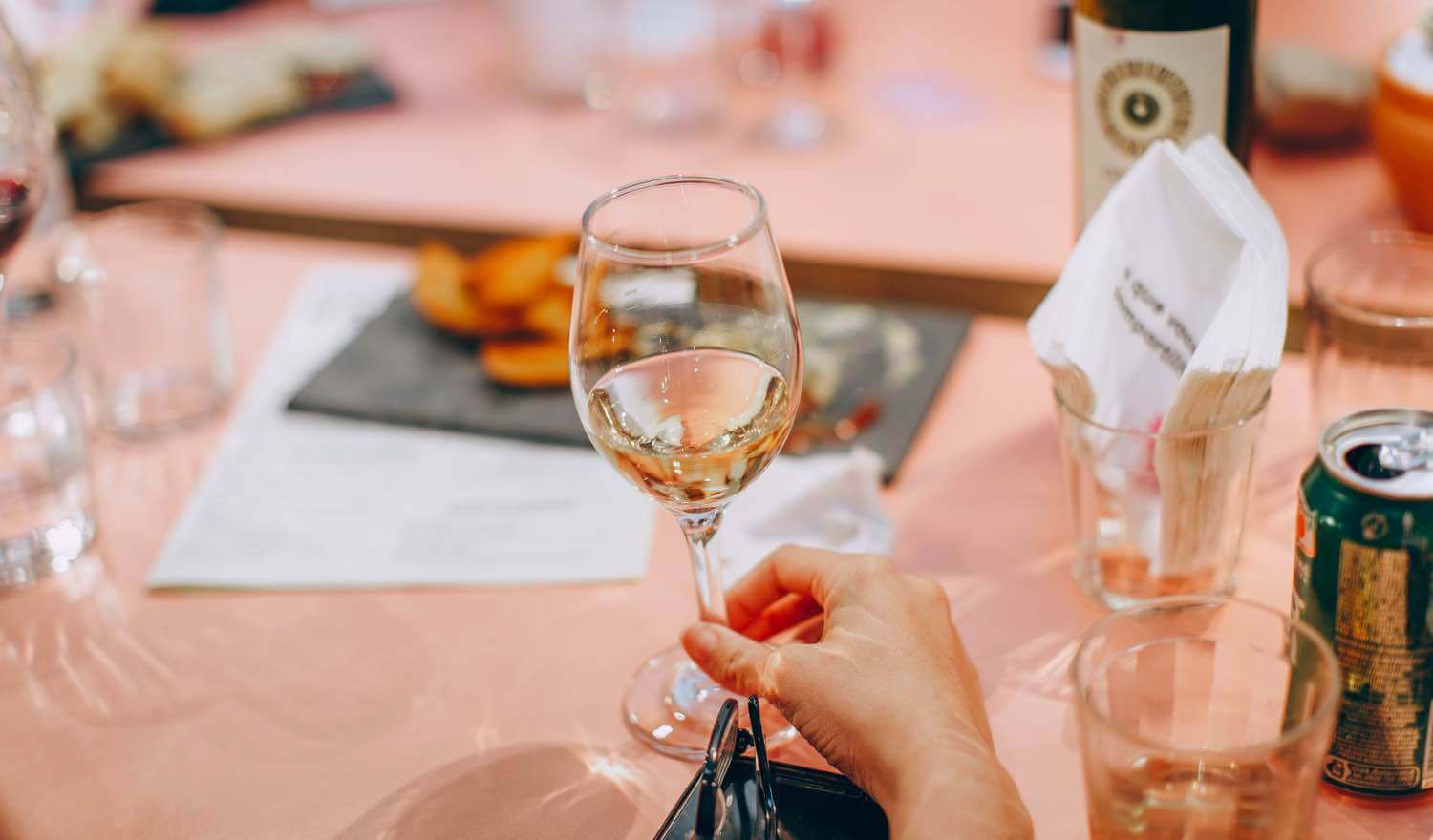 A lady holding up a wine glass ready to cheers