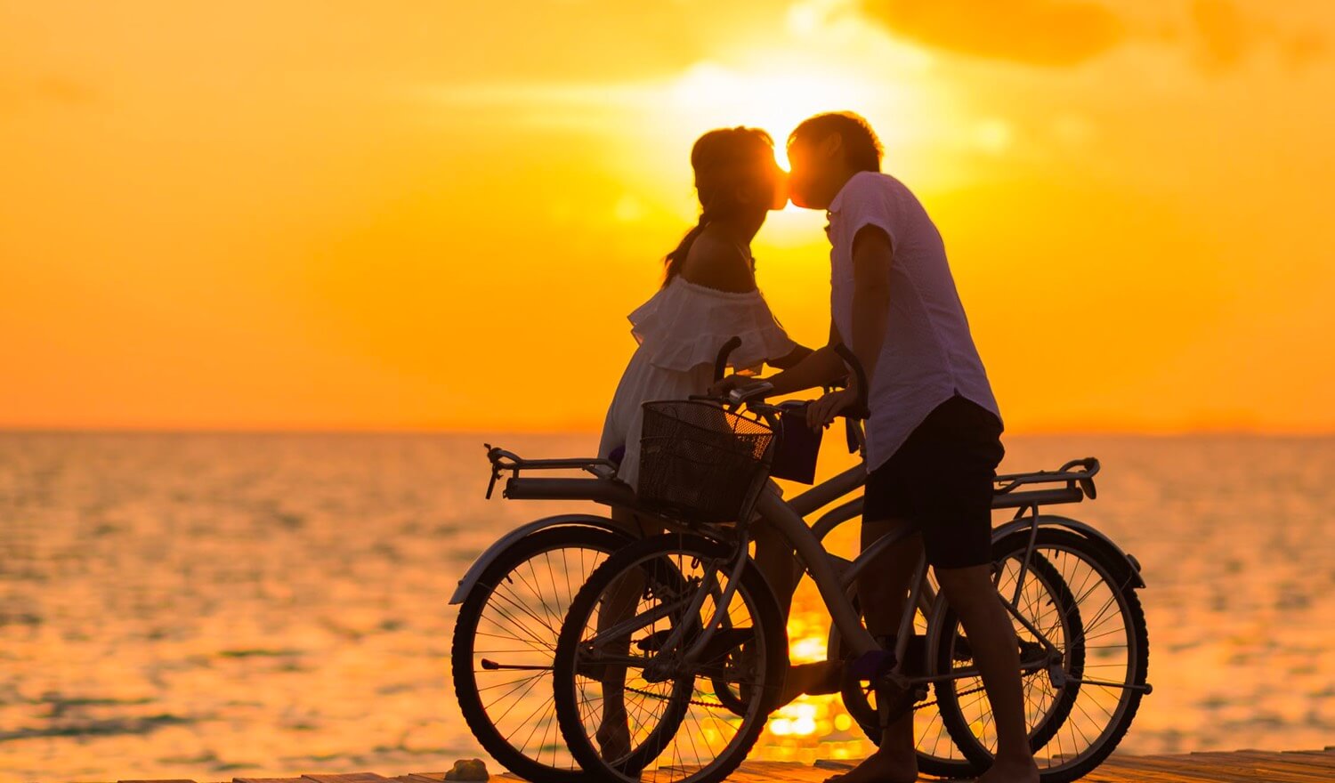 A couple kissing at sunset