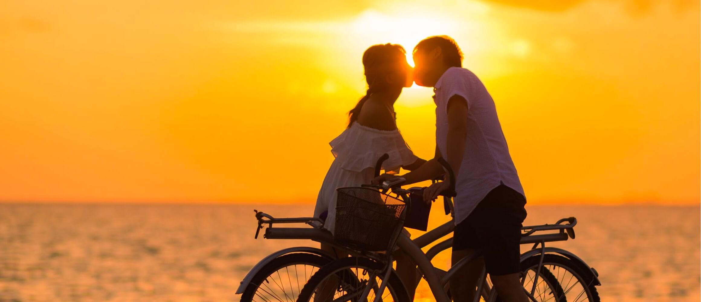 A couple kissing at sunset