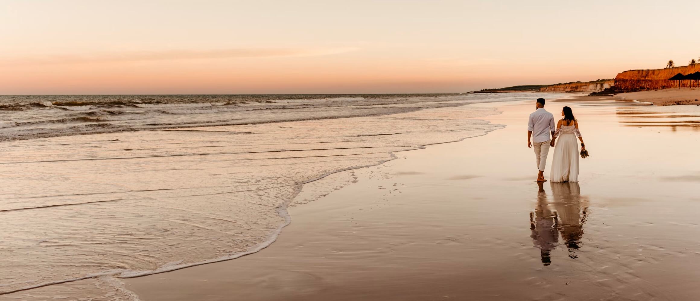 A loving couple walking down the beach