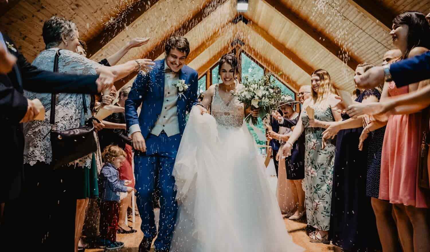 A couple being showered with confetti