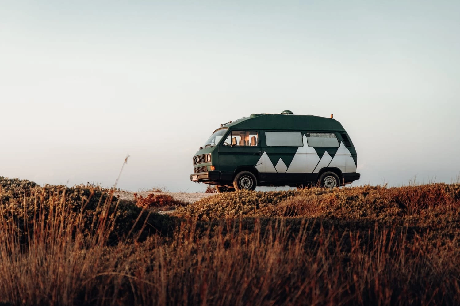 A camper set on a beautiful hill.