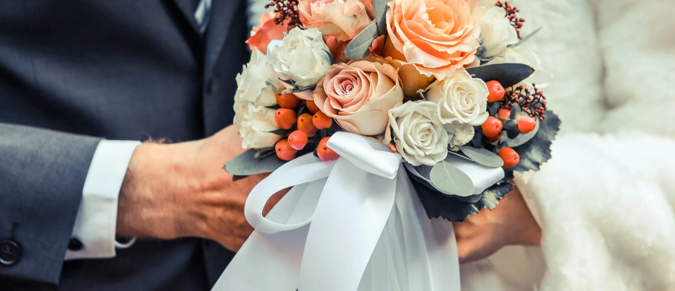 A couple holding a bouquet of flowers