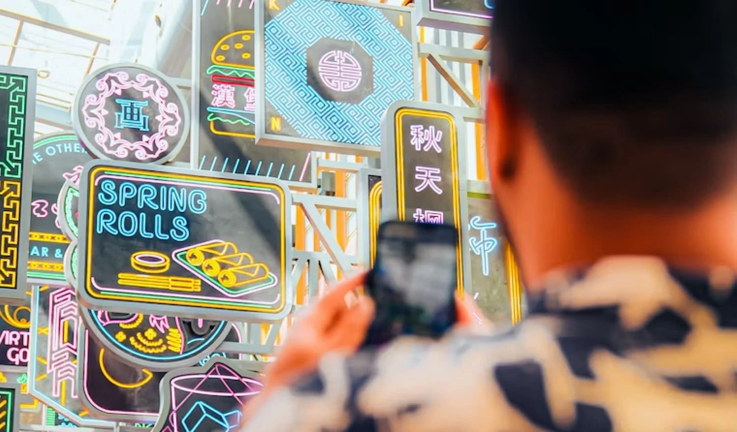 A man taking a photo of Japanese signs