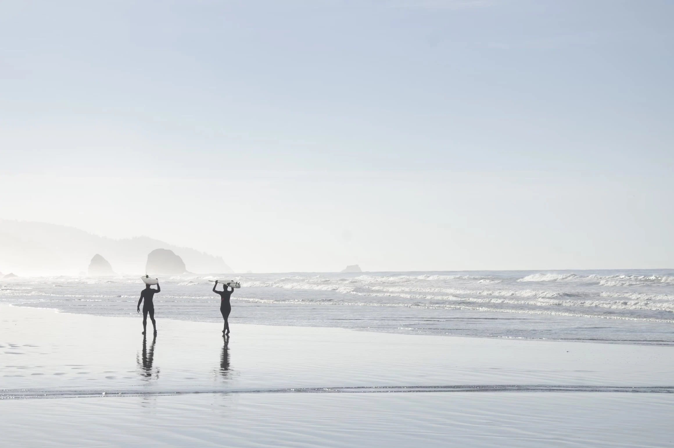 Surfer silhouettes on Cannon Beach