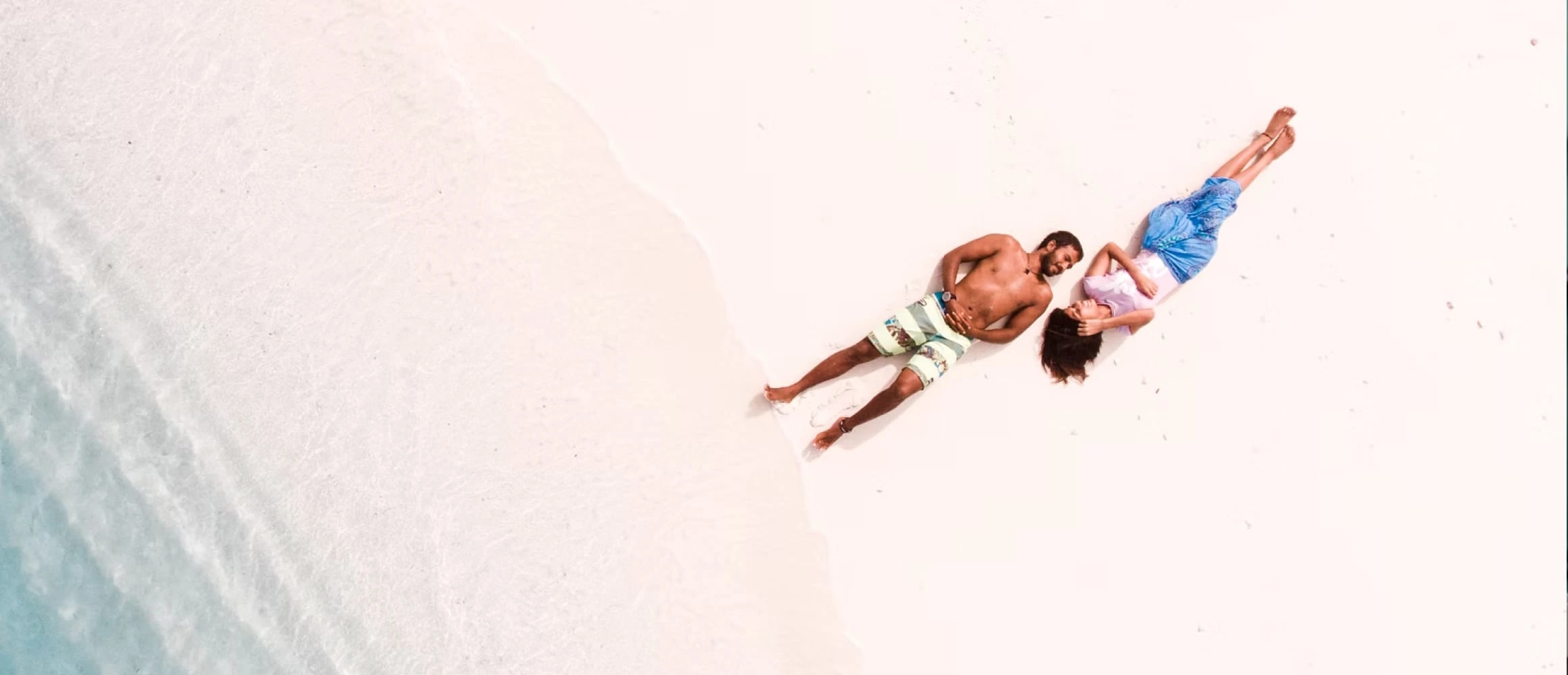 A couple laying on the beach
