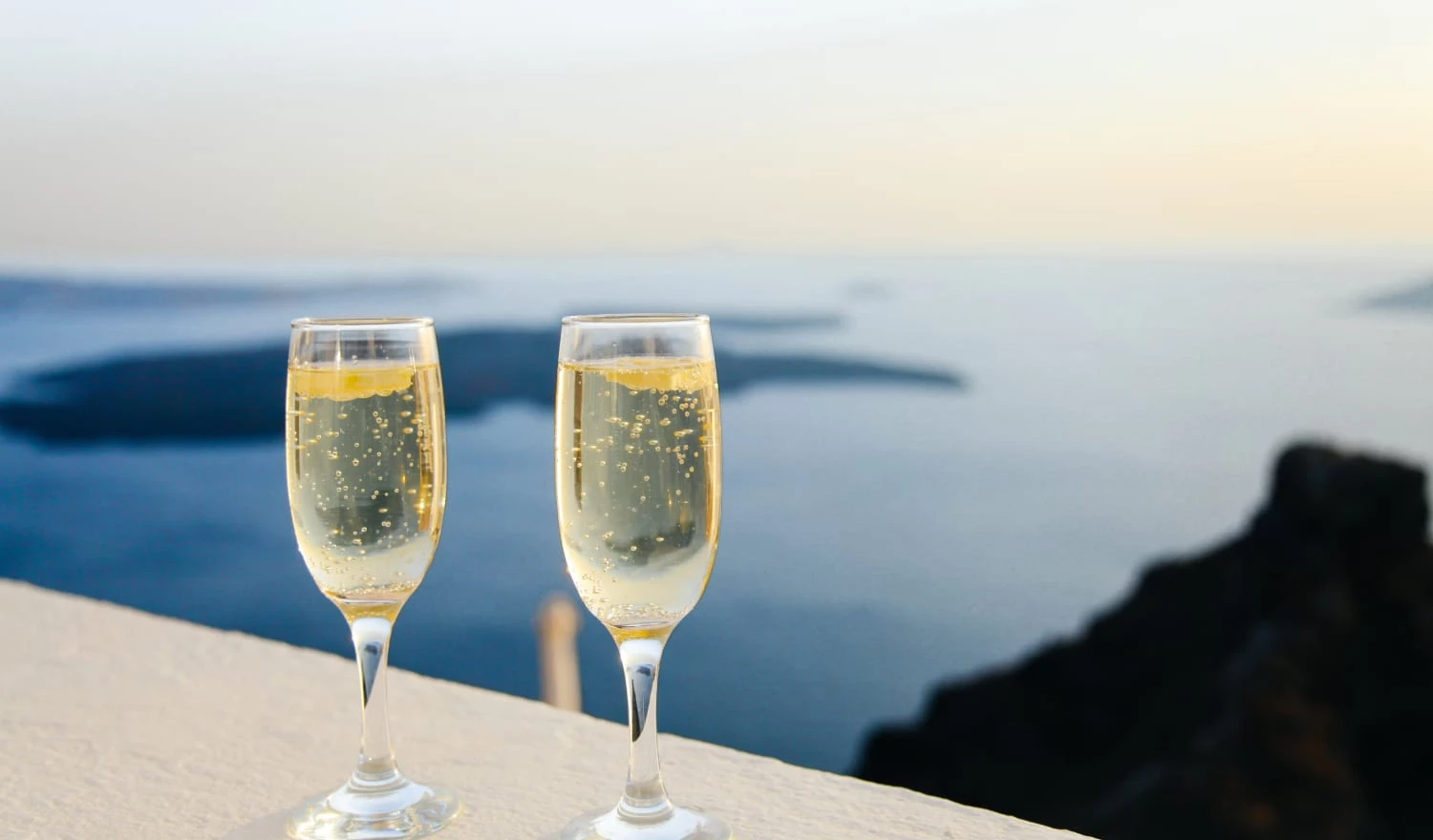 Two champagne glasses about to be consumed by newlyweds