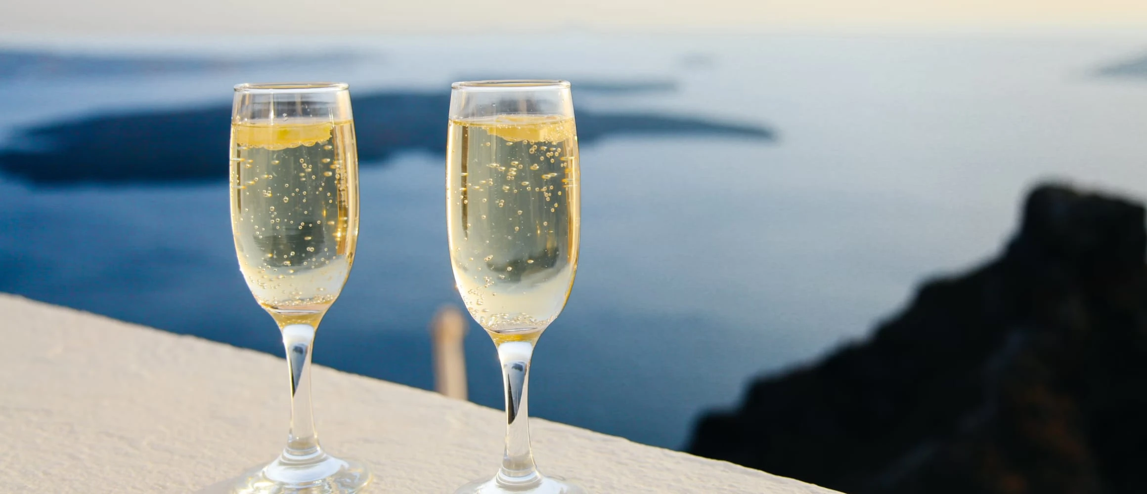 Two champagne glasses about to be consumed by newlyweds