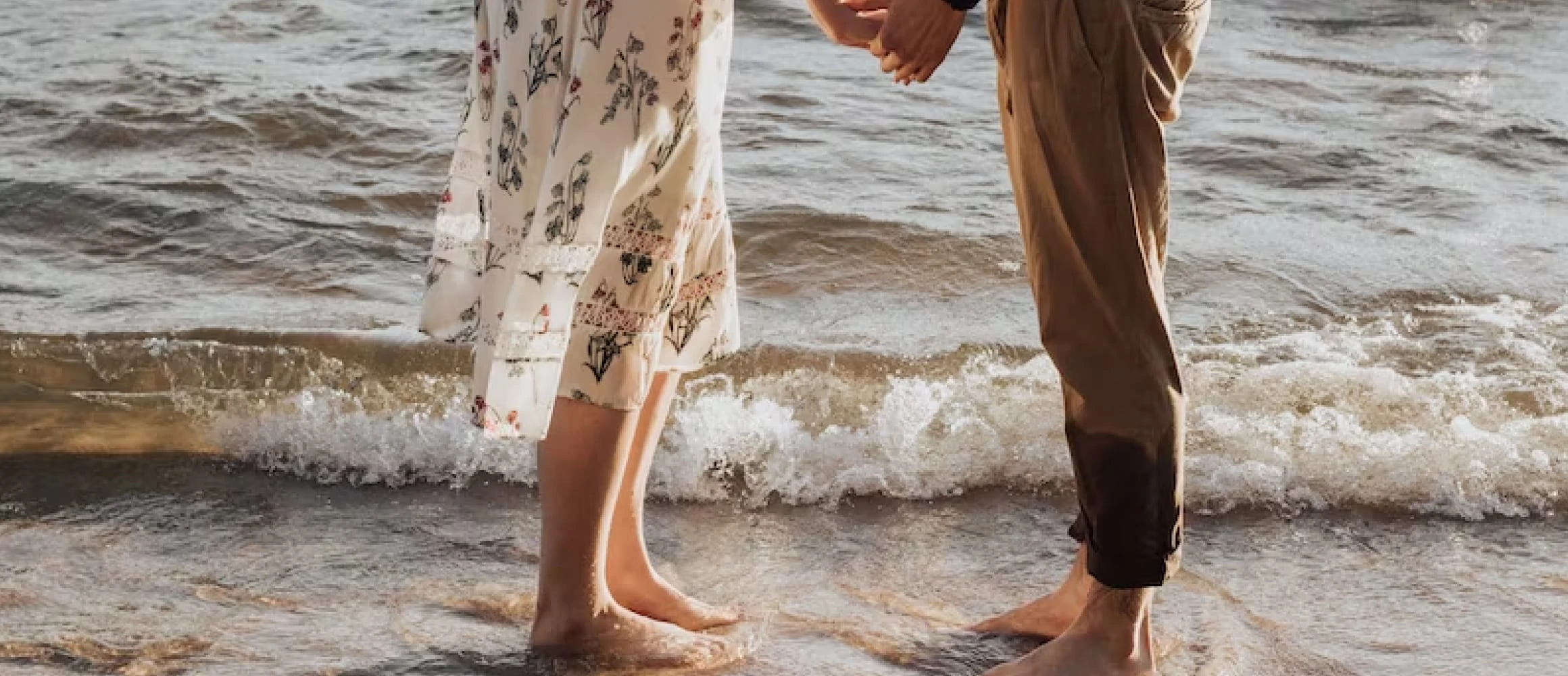 A couple holding hands on the beach